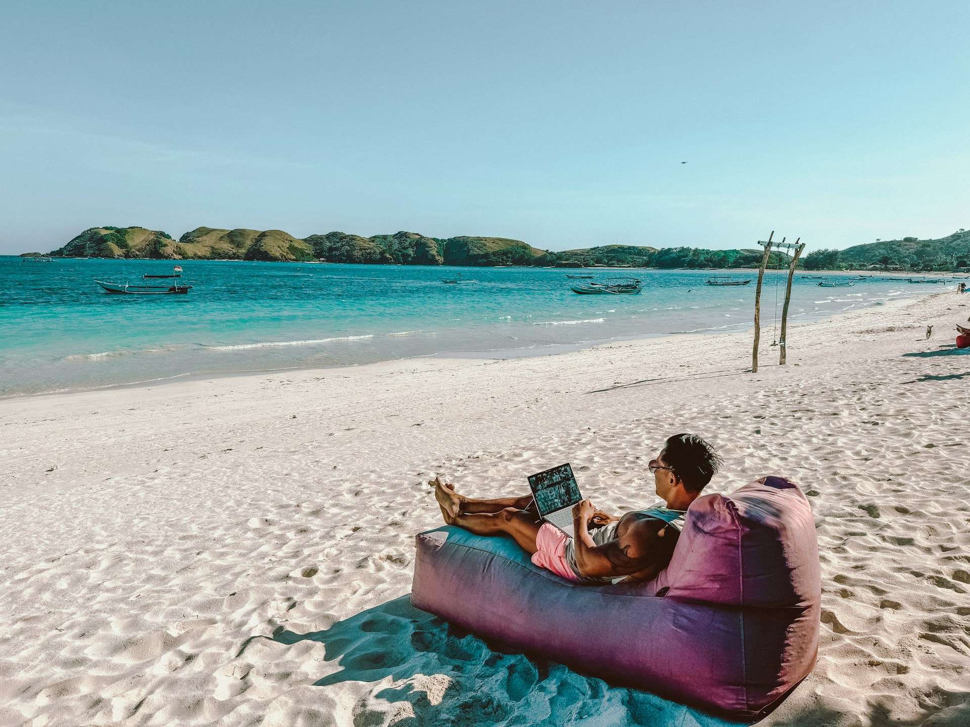 man on bean bag at beach workcation