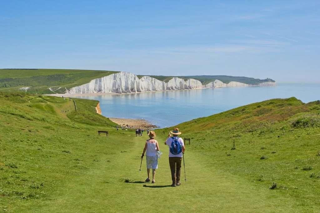 2 people walking toward water UK hiking holiday